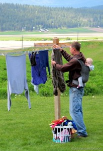 father and son taking down laundry