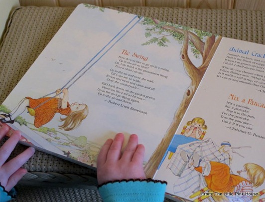 little hands reading "The Swing" in the board book