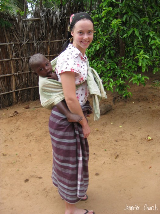 Missionary Jennifer Church babywearing neighbor children in Africa.